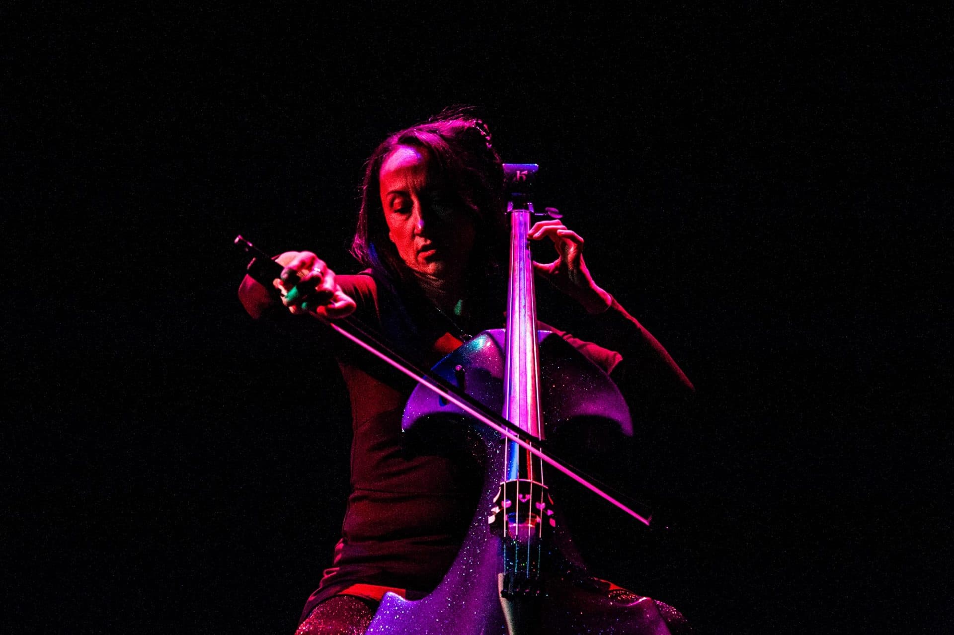 Jo anne cox music Joanne is bathed in red and purple light as she plays with intensity